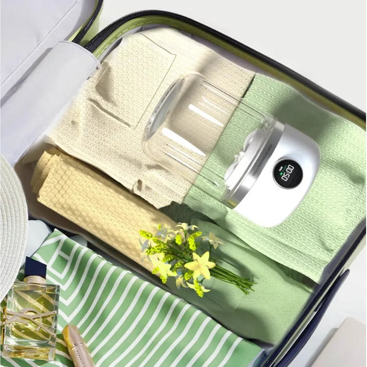 Washeen portable washing machine by Portaboo, compact enough to fit inside a carry-on suitcase for travel-friendly laundry solutions.
